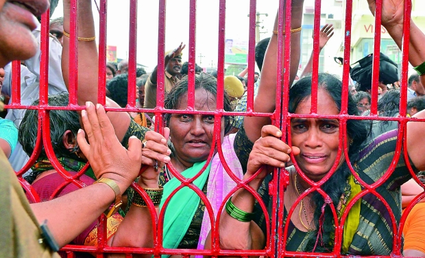 Devotees crying after seeing the stampede at the Godavari ghat who came for a holy dip on occasion of Pushkaralu Devotees crying after seeing the stampede at the Godavari ghat who came for a holy dip on occasion of Pushkaralu